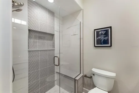 a bathroom with a toilet and a shower