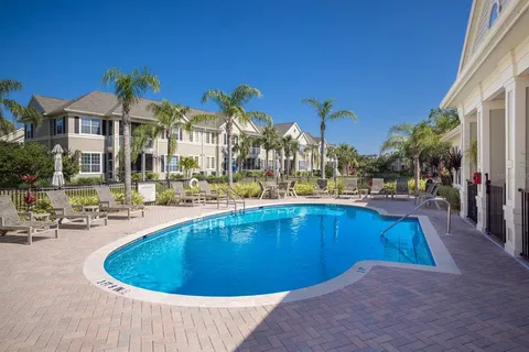 a view of a swimming pool with outdoor seating