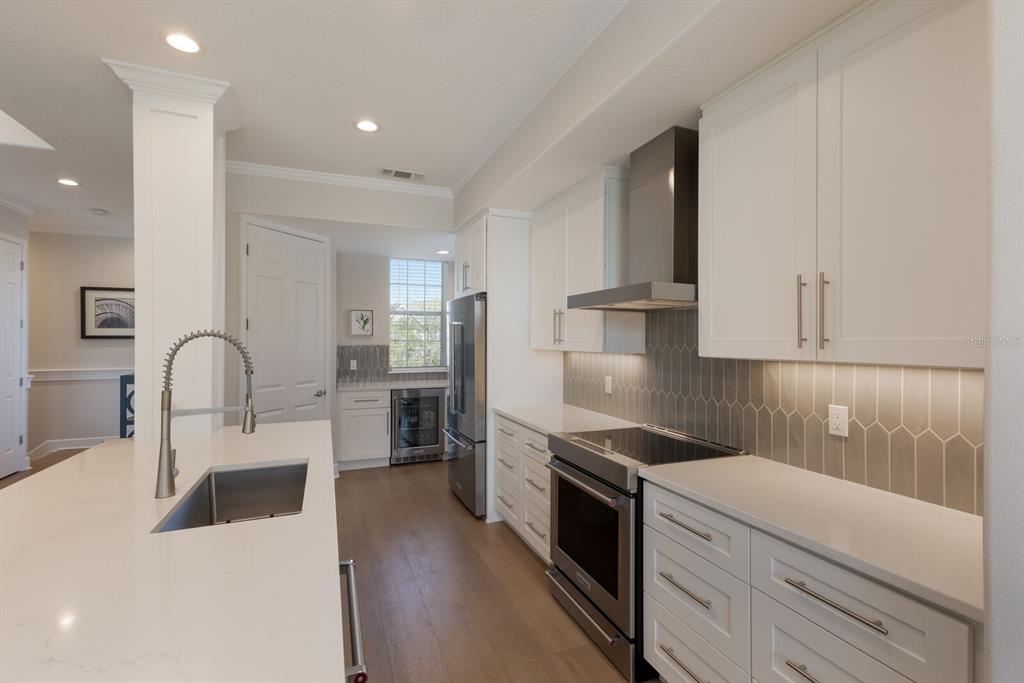 8035 St Simons Street, Unit 8035 University Park, FL 34201 - Photo 5 of 33 a kitchen with a sink white cabinets and stainless steel appliances