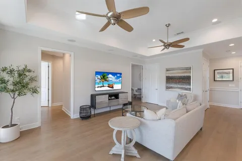 a living room with furniture a dining table and a potted plant