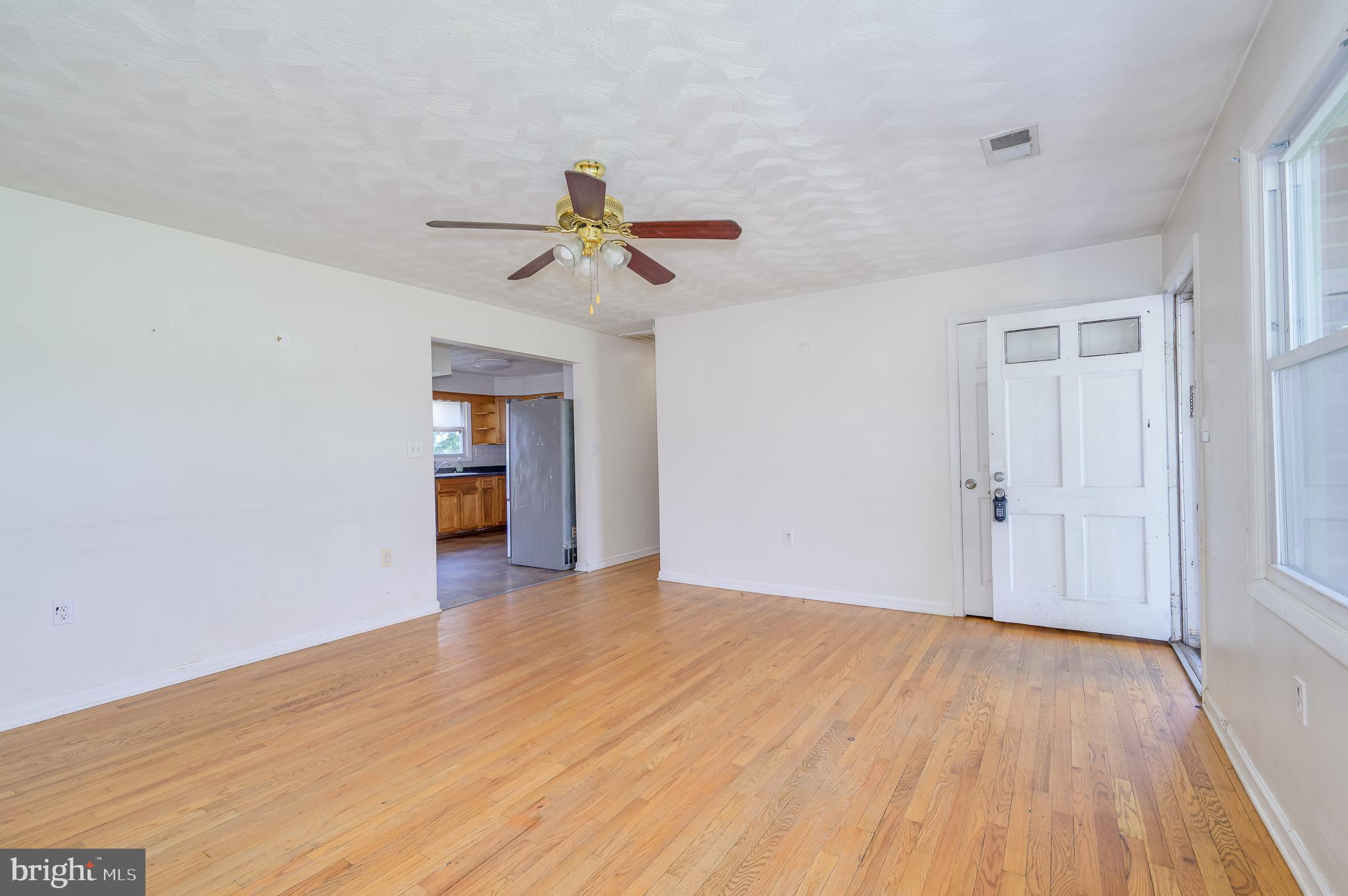 3208 Old Leetown Pike Ranson, WV 25438 - Photo 11 of 48 wooden floor in an empty room with a window