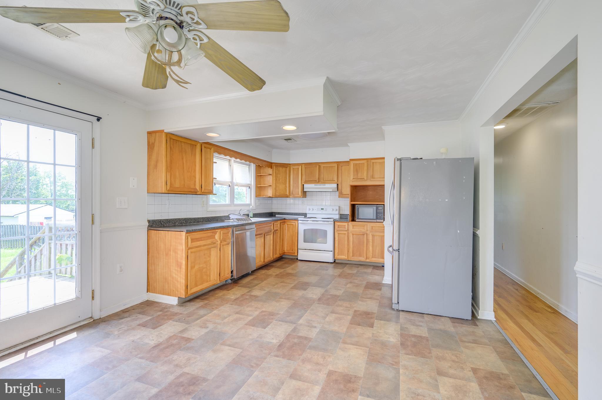 3208 Old Leetown Pike Ranson, WV 25438 - Photo 12 of 48 a large kitchen with a sink and cabinets