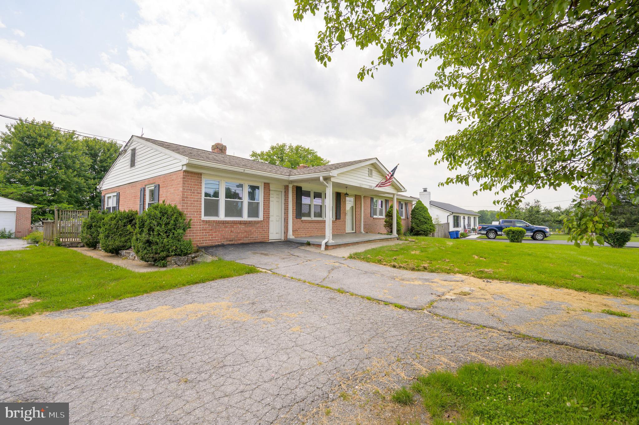 3208 Old Leetown Pike Ranson, WV 25438 - Photo 2 of 48 a view of a house with a yard and large trees