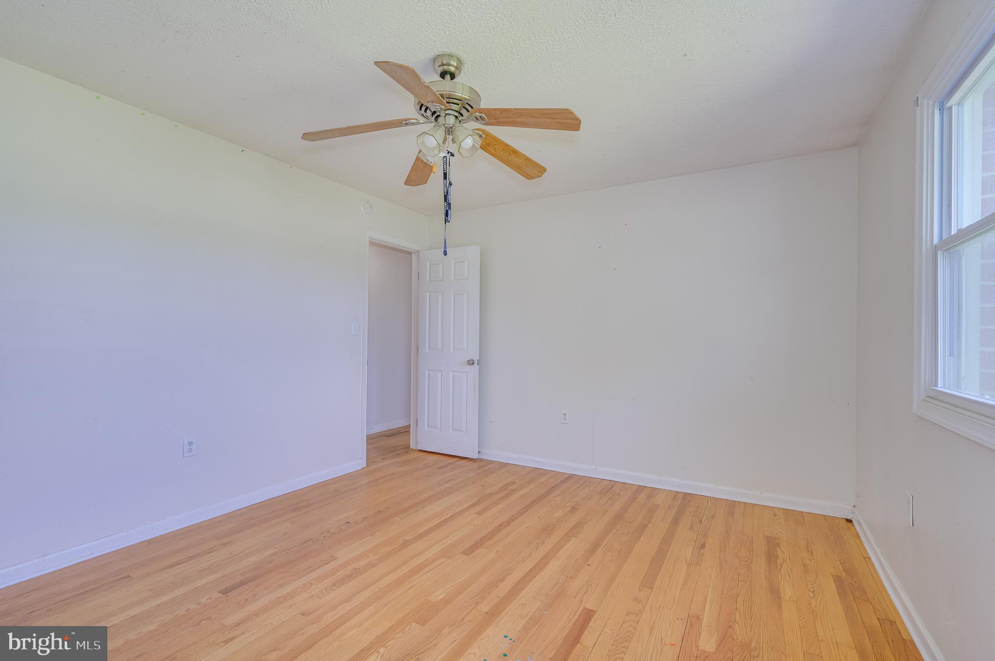 3208 Old Leetown Pike Ranson, WV 25438 - Photo 24 of 48 a view of empty room with wooden floor and ceiling fan