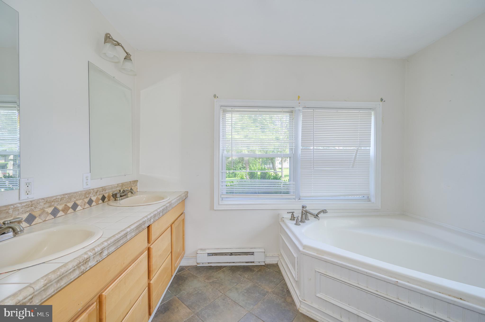 3208 Old Leetown Pike Ranson, WV 25438 - Photo 27 of 48 a spacious bathroom with a tub sink and a window