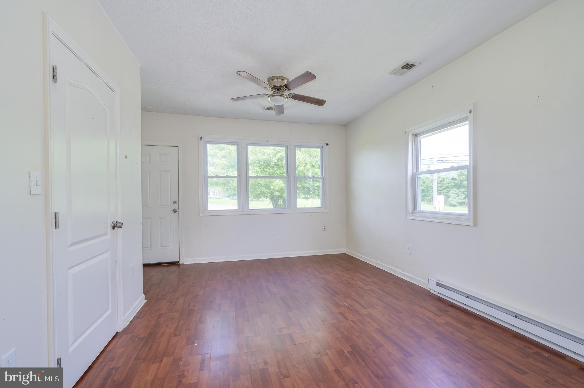 3208 Old Leetown Pike Ranson, WV 25438 - Photo 29 of 48 wooden floor in an empty room with a window