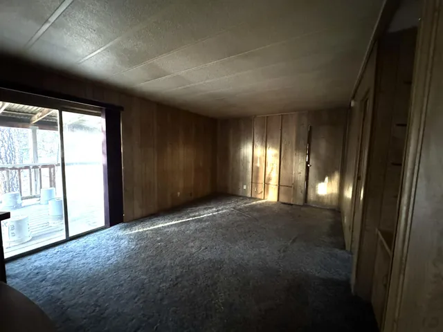 a view of a hallway with wooden shelves