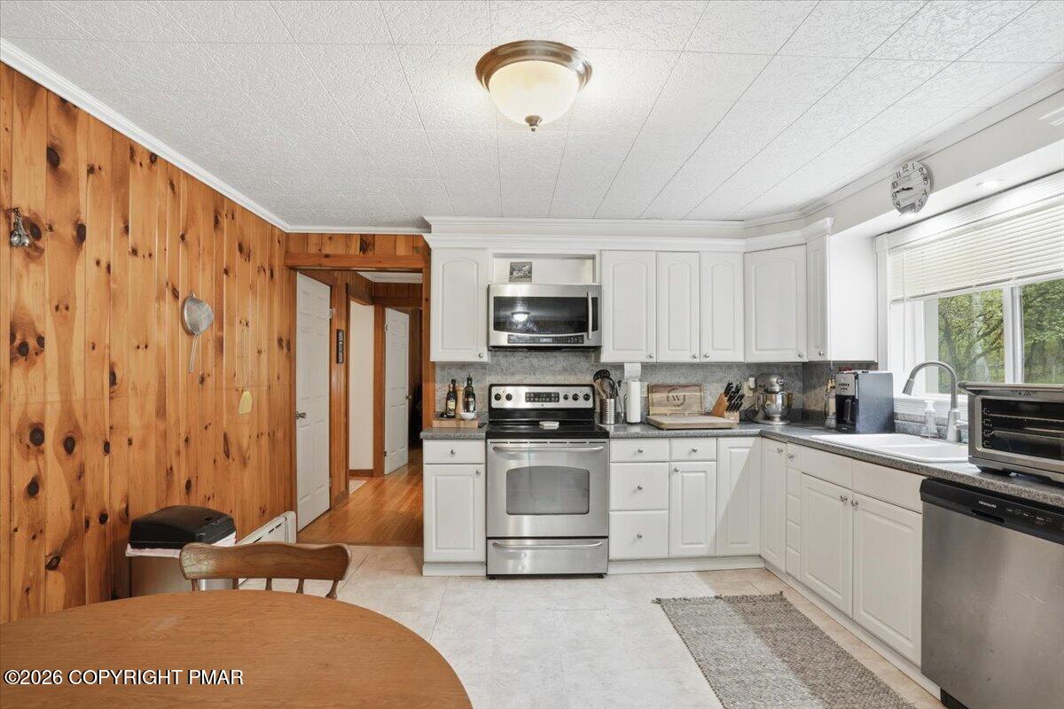 232 Garrity Road Hawley, PA 18428 - Photo 25 of 57 a kitchen with stainless steel appliances granite countertop a stove a sink and a refrigerator