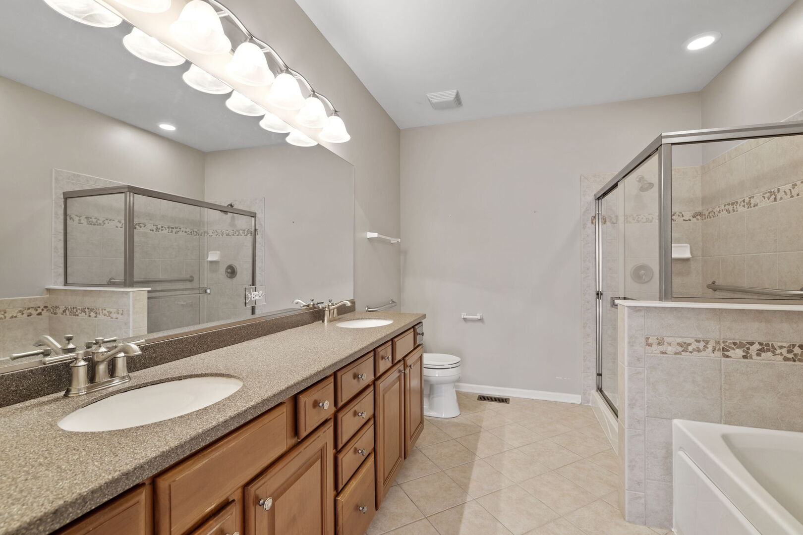 2845 Bond Circle Naperville, IL 60563 - Photo 18 of 27 a bathroom with a granite countertop sink a mirror and a shower