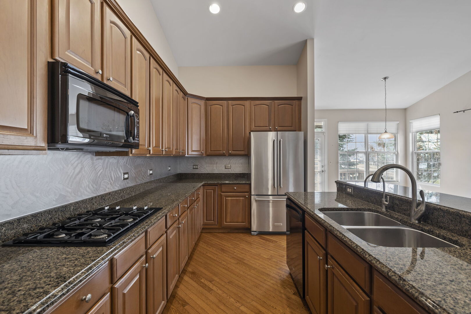 2845 Bond Circle Naperville, IL 60563 - Photo 5 of 27 a kitchen with stainless steel appliances granite countertop a sink stove and refrigerator