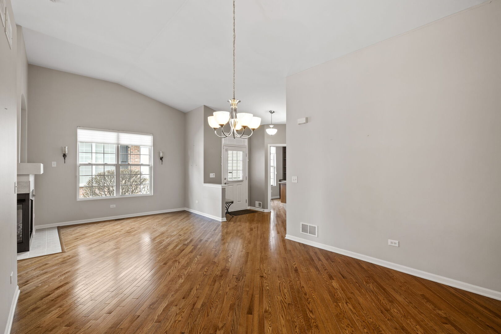 2845 Bond Circle Naperville, IL 60563 - Photo 8 of 27 a view of a room with wooden floor and chandelier