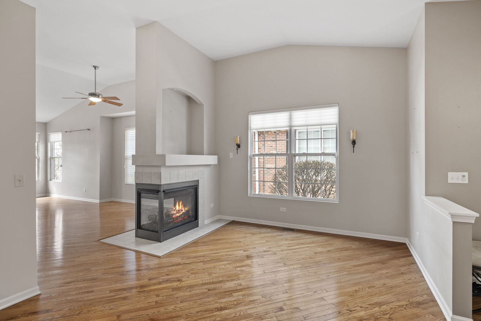 2845 Bond Circle Naperville, IL 60563 - Photo 9 of 27 a view of an empty room with wooden floor fireplace and a window