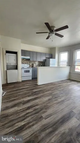 a view of empty room with window and wooden floor