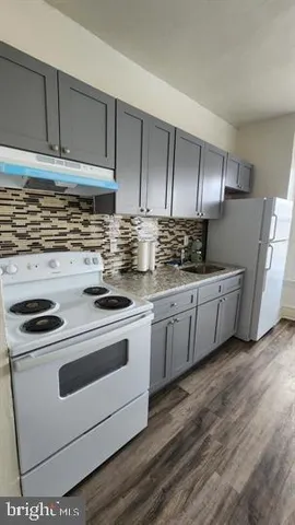 a kitchen with stainless steel appliances a stove microwave and cabinets