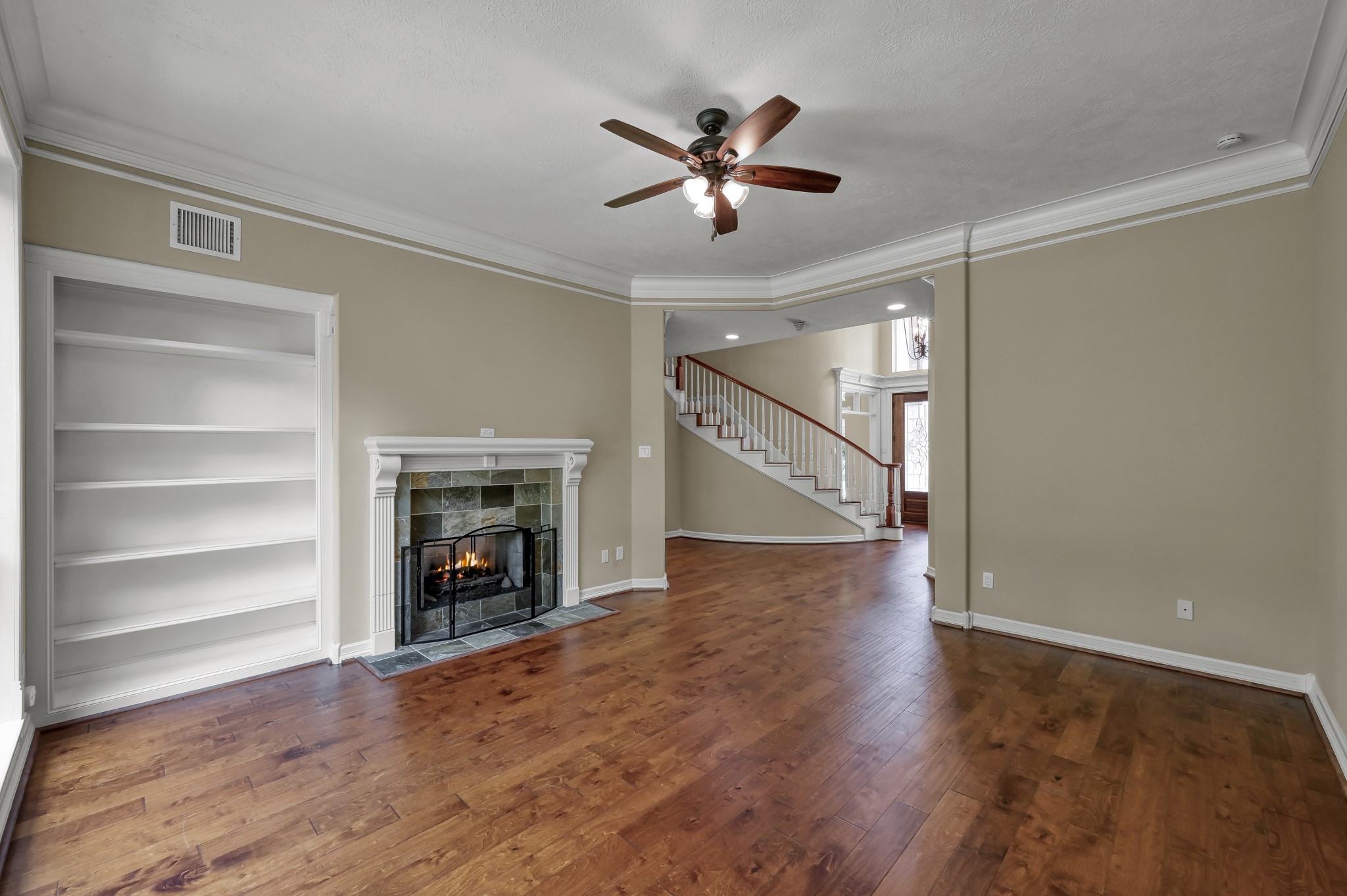 2205 Longmire Road Conroe, TX 77304 - Photo 9 of 49 Another view of the formal living room with built in bookshelves and a fire place that opens on the other side as well to the family room.