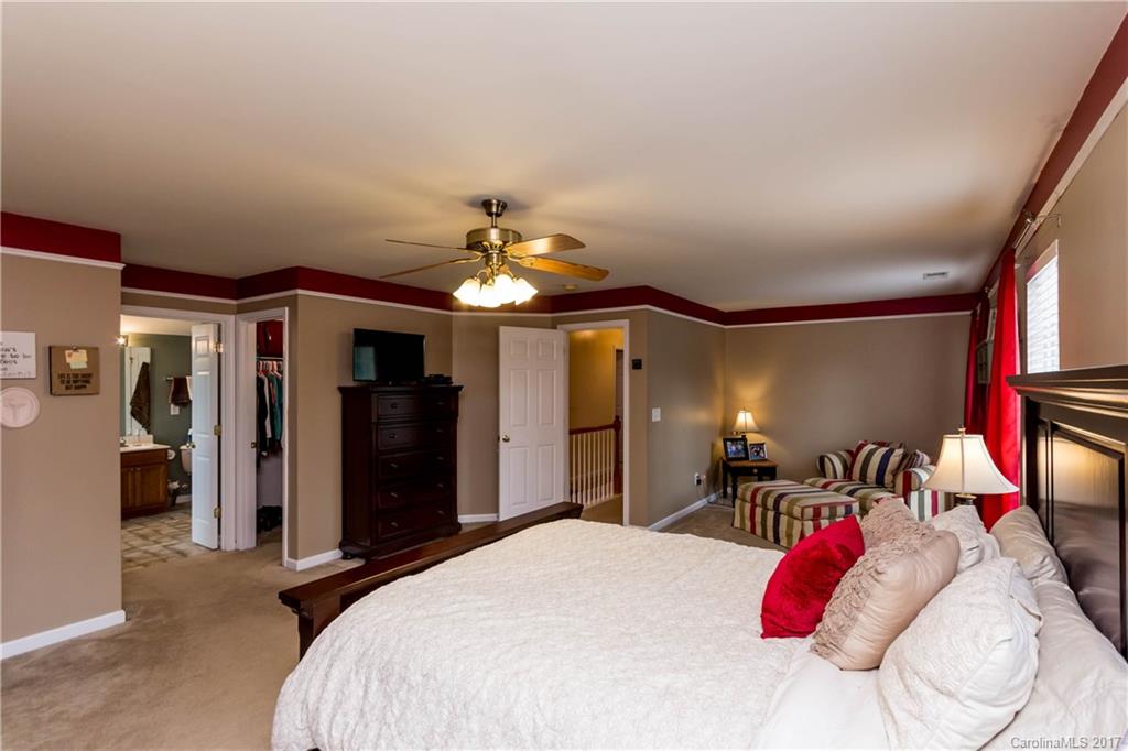 5556 Alexandrite Way Fort Mill, SC 29708 - Photo 15 of 20 a bedroom with a bed and a chandelier