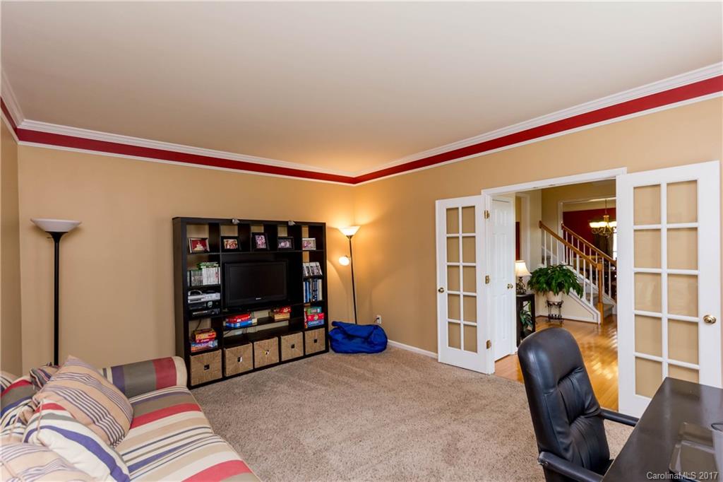 5556 Alexandrite Way Fort Mill, SC 29708 - Photo 3 of 20 a living room with furniture a flat screen tv and a large window