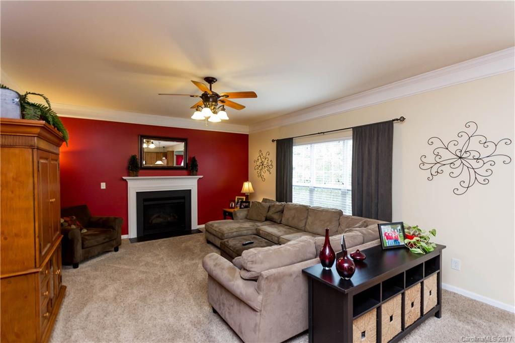 5556 Alexandrite Way Fort Mill, SC 29708 - Photo 9 of 20 a living room with furniture a chandelier and a window