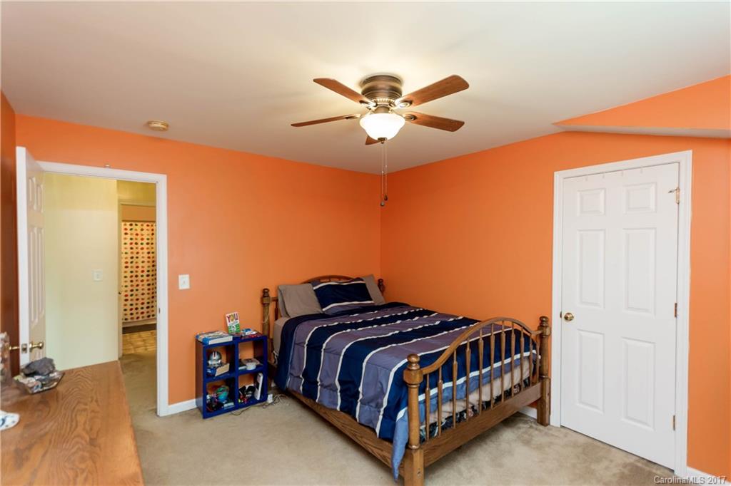 5556 Alexandrite Way Fort Mill, SC 29708 - Photo 10 of 20 a bedroom with a bed and a chandelier