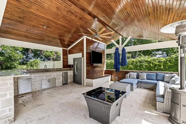 a living room with patio furniture and a floor to ceiling window