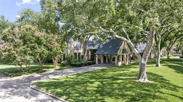 an aerial view of residential house with outdoor space and trees all around