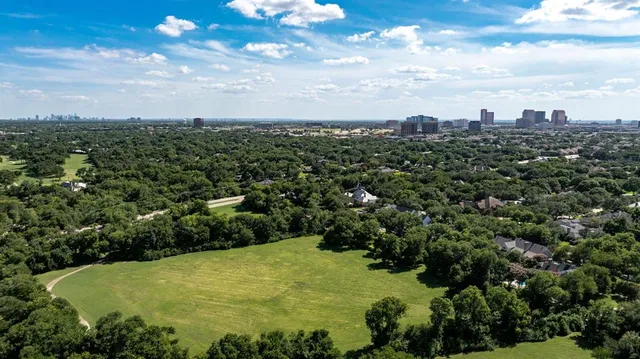 an aerial view of a house with yard