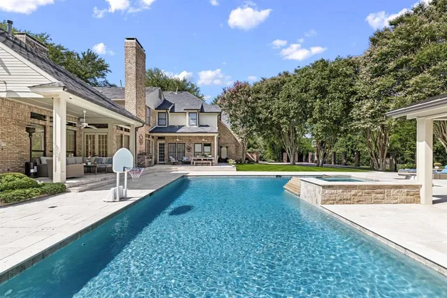 a view of a house with swimming pool and yard