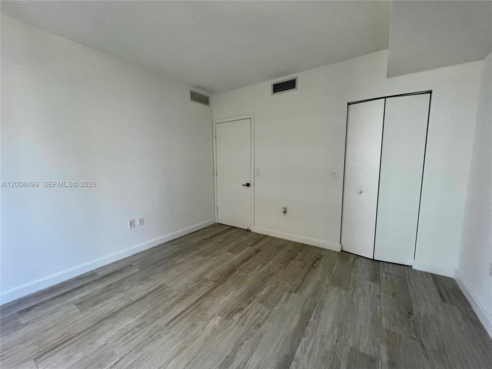 55 Southwest 9th Street, Unit 2702 Miami, FL 33130 - Photo 12 of 36 a view of a room with wooden floor
