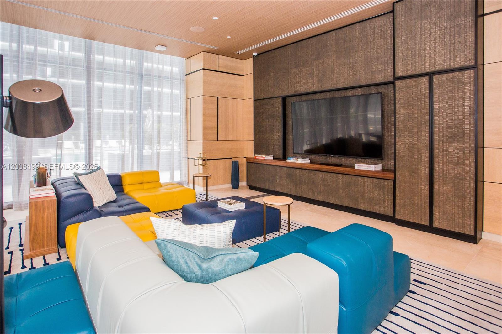 55 Southwest 9th Street, Unit 2702 Miami, FL 33130 - Photo 29 of 36 a living room with furniture and flat screen tv