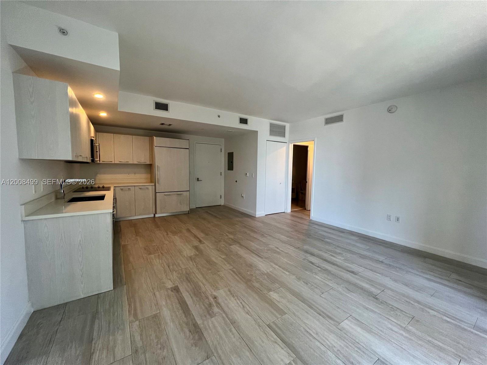 55 Southwest 9th Street, Unit 2702 Miami, FL 33130 - Photo 7 of 36 a view of kitchen with wooden floor