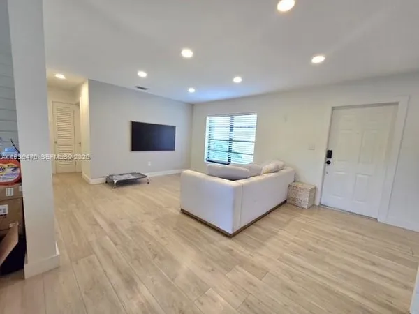 a spacious bedroom with a bed and a large window