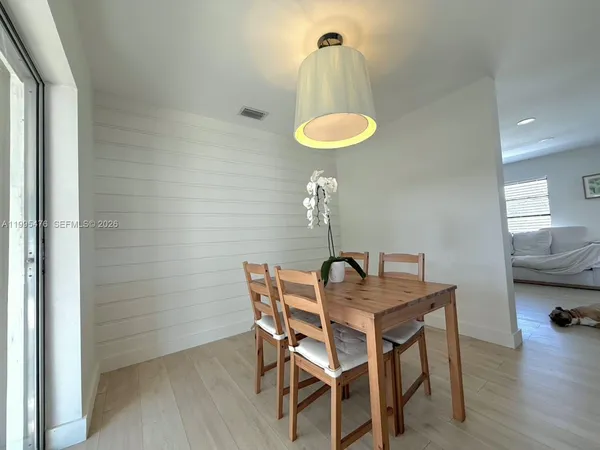 a view of a dining room with furniture and wooden floor