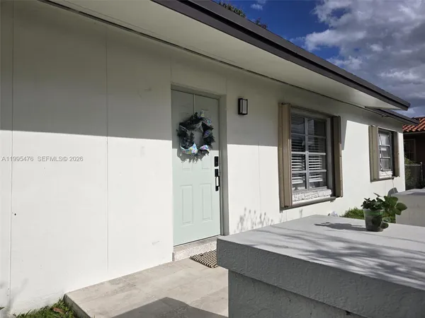 a view of a hallway with a potted plant
