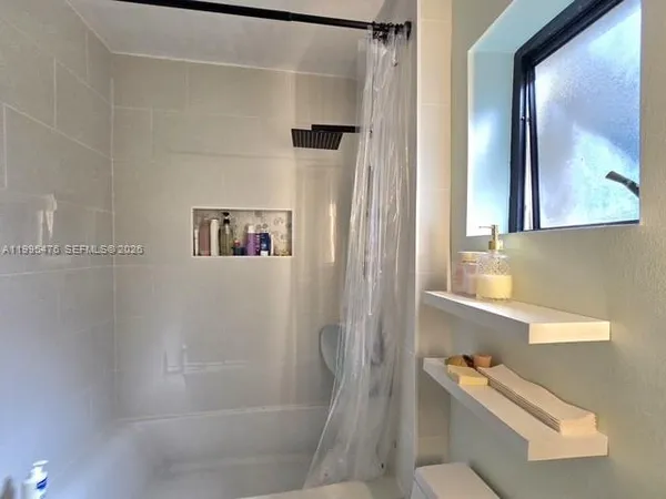a bathroom with a bathtub and a shower