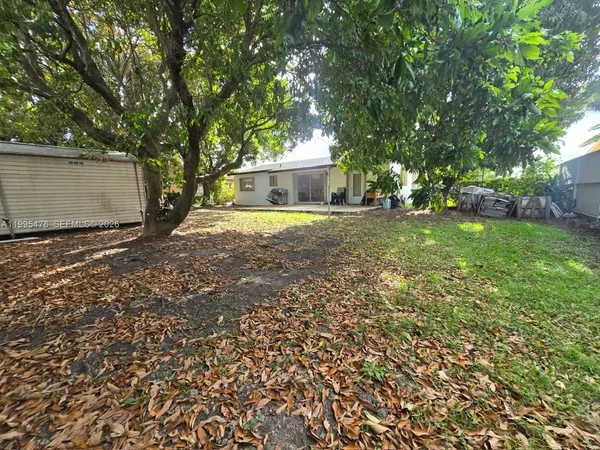 a backyard of a house with yard and outdoor seating