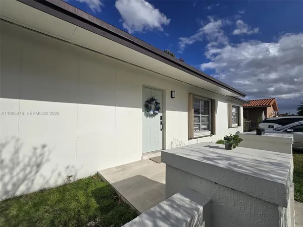 a view of a house with backyard porch and furniture
