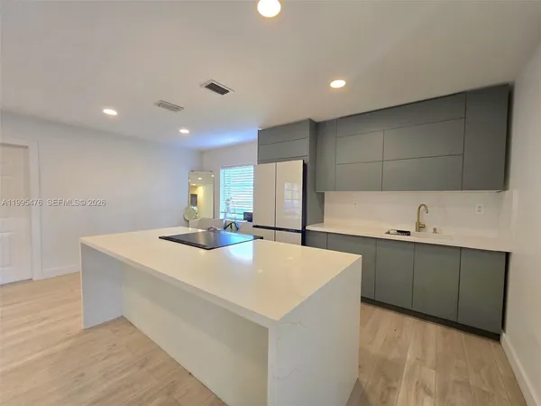 a kitchen with counter top space and sink