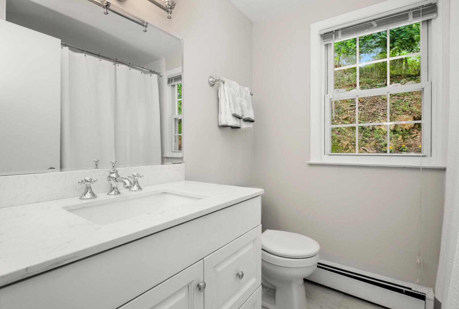 210 Tokeneke Road Darien, CT 06820 - Photo 19 of 24 a bathroom with a sink a toilet and a mirror