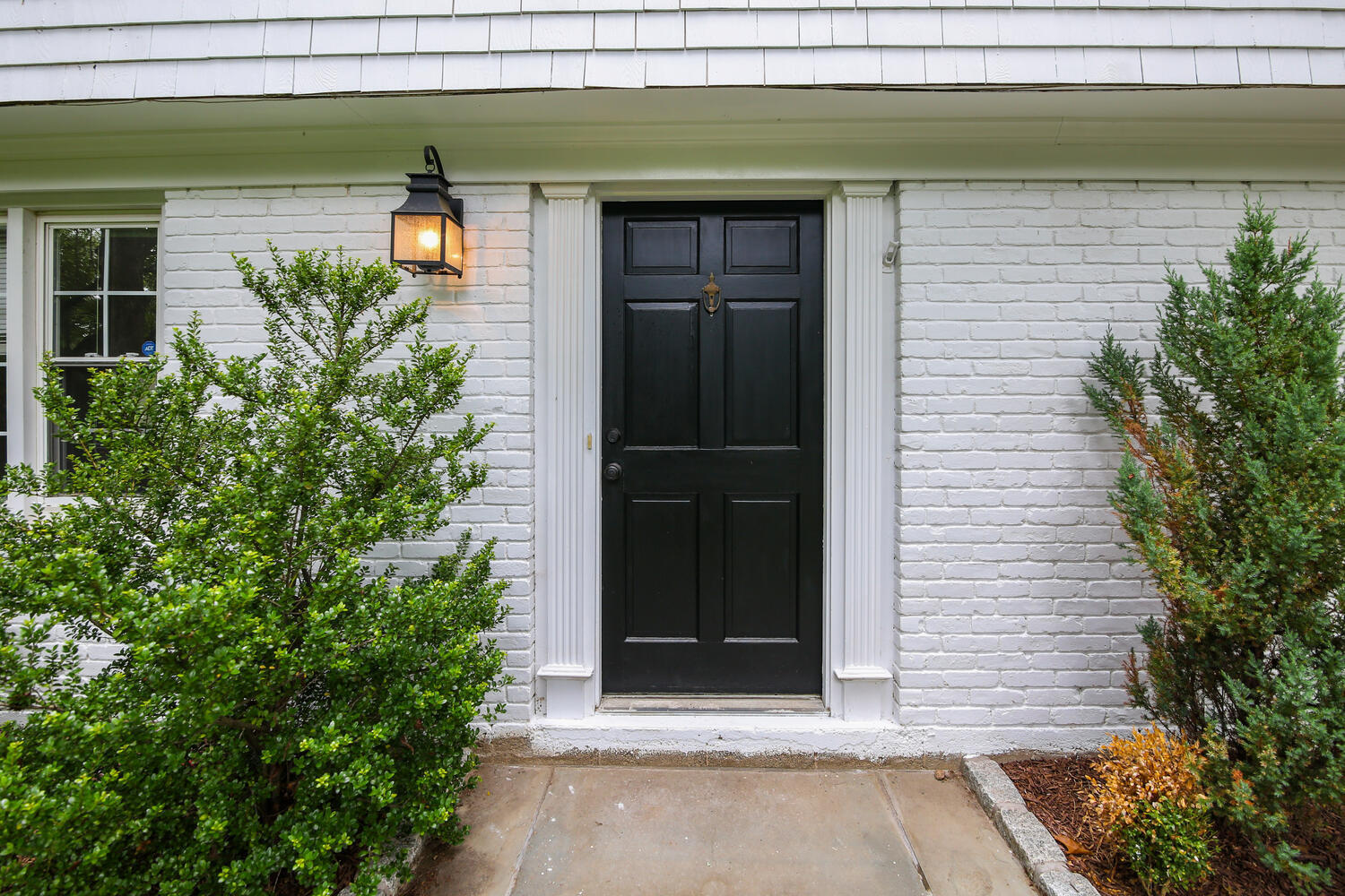 210 Tokeneke Road Darien, CT 06820 - Photo 3 of 24 a potted plant in front of a door
