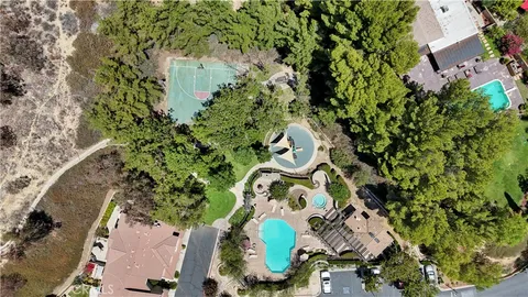 an aerial view of a house with a yard and garden