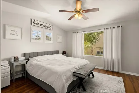 a bed sitting in a bedroom next to a window