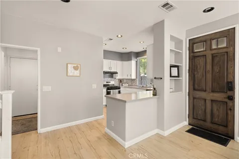 a kitchen with stainless steel appliances granite countertop a refrigerator and a stove top oven