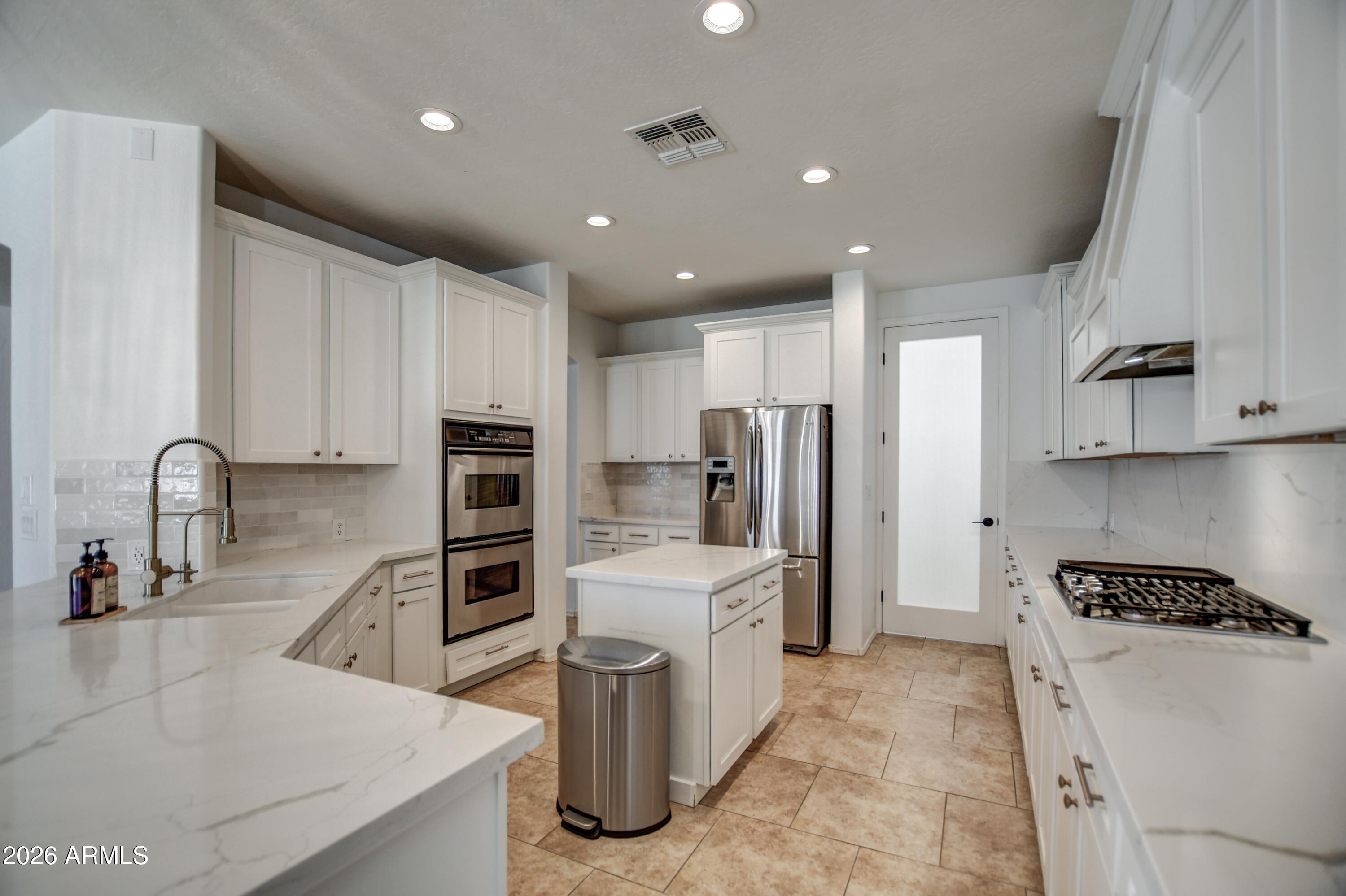 3078 East Muirfield Street Gilbert, AZ 85298 - Photo 35 of 92 a kitchen with refrigerator and cabinets