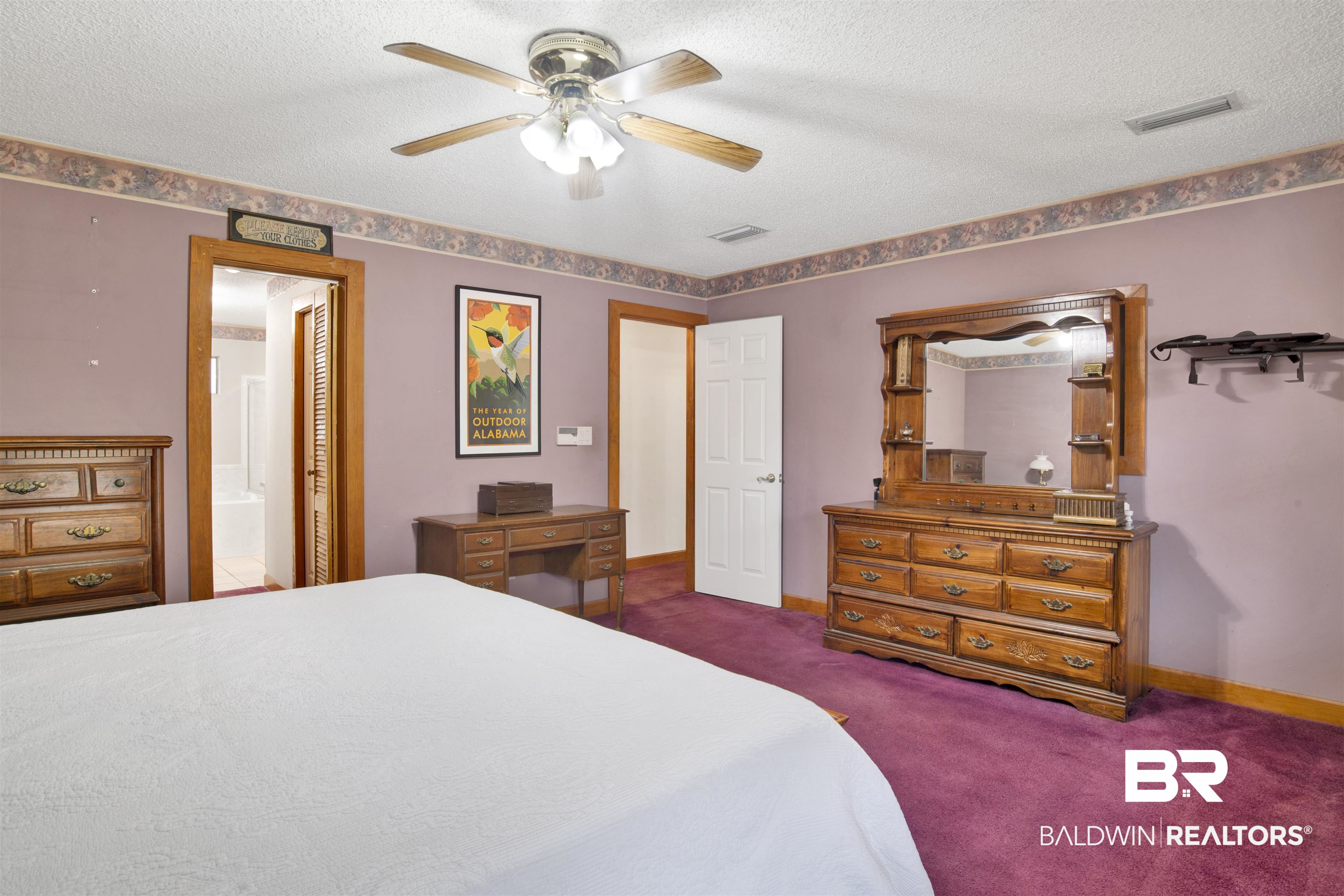 4890 Red Creek Road Semmes, AL 36575 - Photo 19 of 47 Bedroom featuring a textured ceiling, ensuite bath, dark carpet, and ceiling fan