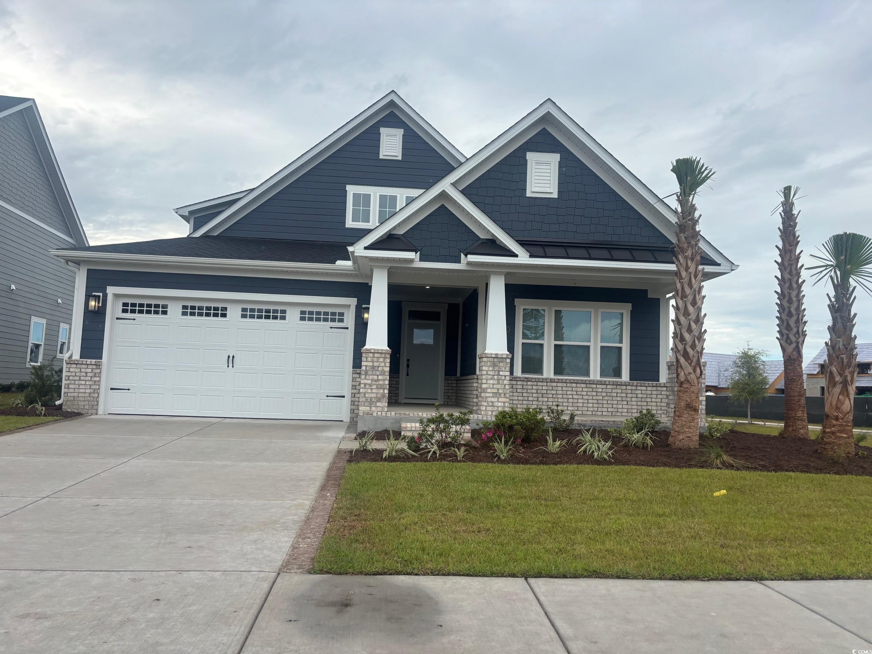 2353 Hazel Way Longs, SC 29568 - Photo 1 of 1 View of front of house with driveway, a front lawn, brick siding, and an attached garage