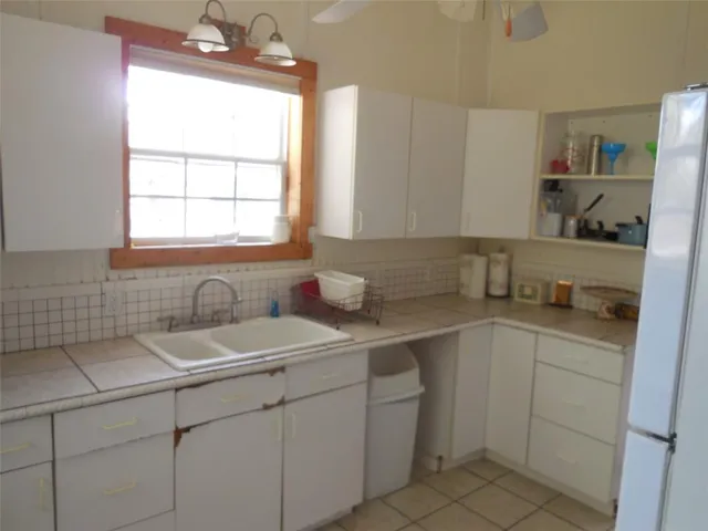a kitchen with a sink cabinets and window