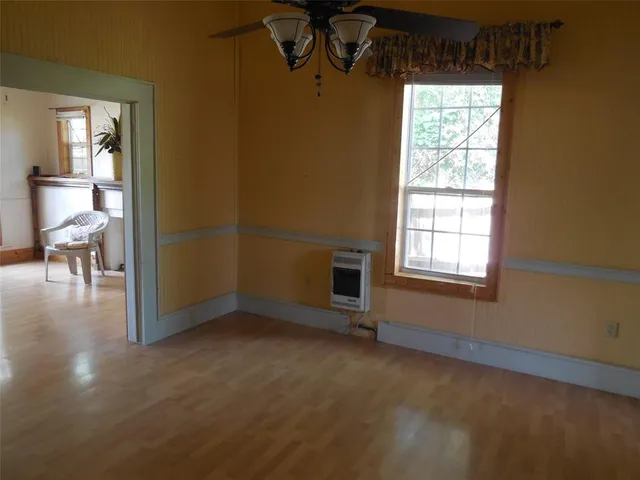 an empty room with windows and chandelier
