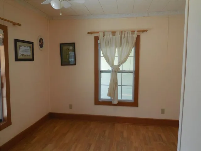 an empty room with windows and closet