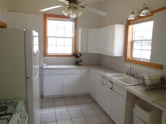 a kitchen with a sink cabinets and window