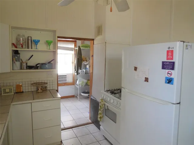 a kitchen with a refrigerator and a stove